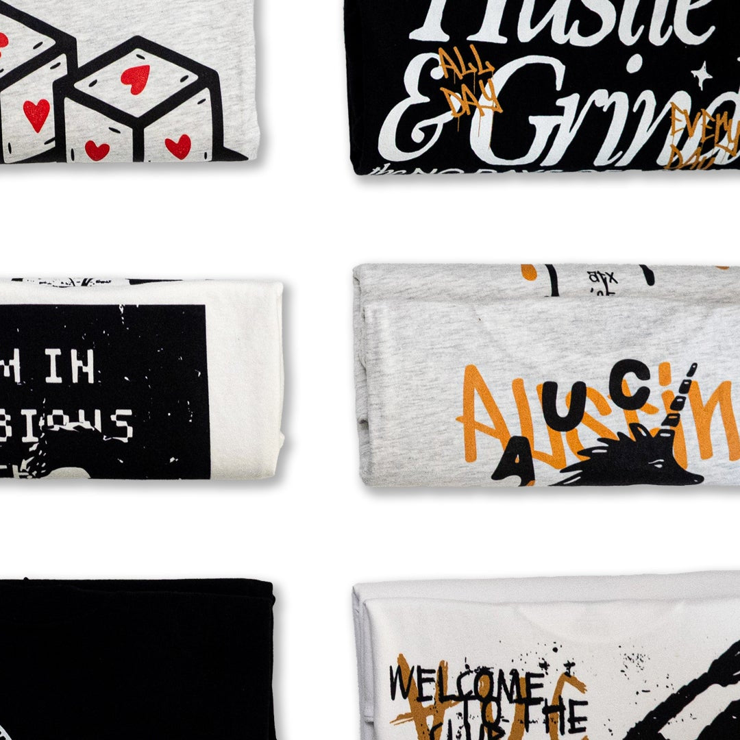 A collection of various printed AUC lightweight tees with different designs and text on a white background.