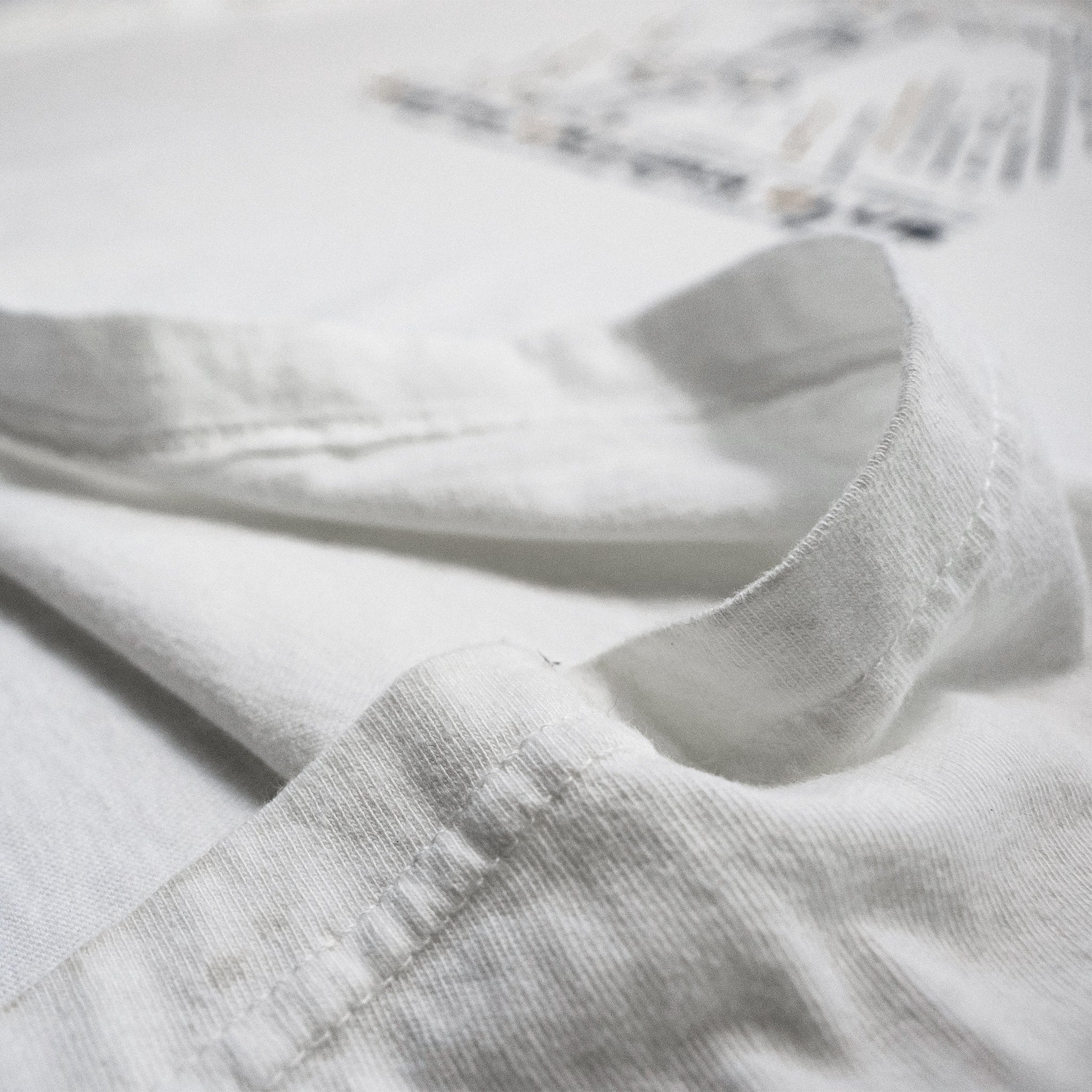 Shake Them Haters Off - Heavyweight White Tee - Image of fabric material up close - Austin Unicorn Club Apparel
